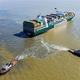 Tug boats pull on the Ever Forward container ship.
